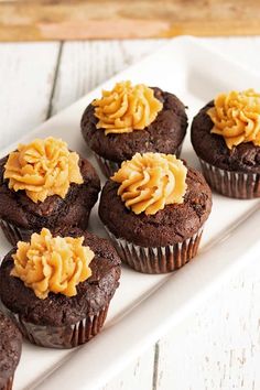 chocolate cupcakes with peanut butter frosting on a white plate