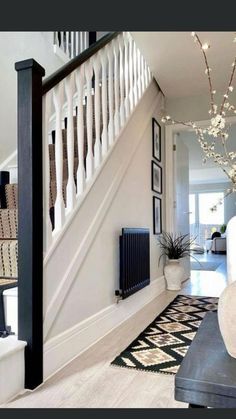 an entry way with stairs and vases on the floor