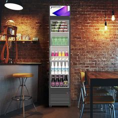 a vending machine in the middle of a room with tables and chairs around it