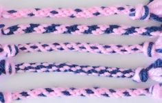 four pink and blue crocheted ropes on a white surface