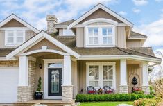 a house with white shutters and green grass on the front lawn is pictured in this image