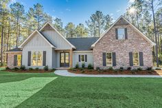 a house that is in the grass near trees