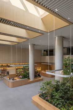 the interior of an office building with plants and bookshelves hanging from the ceiling