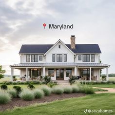 a large white house sitting on top of a lush green field