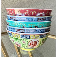 Excellent Pre-Owned Condition.  Colorful, mixed set of porcelain rice bowls and assorted pattern spoons. There is one wan shou wu jiang bowl (万寿无疆) that is unmarked with a Greek key border motif on the lip. Two other bowls, also with the Greek key motif, are decorated with cherry blossom and peony floral motifs; both are unmarked. The last two bowls have incised exteriors with a motif consisting of bats and peonies with “Decorated in Hong Kong” on the underside of each. The five spoons are all v Pottery Patterns, Bowl Designs, Rice Bowl, Greek Key, Spoon Set, Rice Bowls, Pottery Painting, Pattern Mixing, Floral Motifs