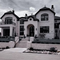 a large white house with stone steps leading up to it