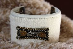 Easy to wear, comfortable and oh-so-western leather cuff with a handmade sterling silver clasp, etched brass end-pieces and a pretty silver concho. These measure 1 3/4" wide by 8" long and fit an average wrist. Simple, understated cowgirl bling to brighten up any outfit. Made to last you a long time, too! Adjustable White Leather Bracelets, Adjustable White Leather Bracelet, White Leather Bohemian Jewelry, White Bohemian Leather Jewelry, Western Leather Jewelry With Concho, Bohemian White Leather Jewelry, Western Style Leather Bracelet With Concho, Western Style Leather Bracelet With Concho As Gift, Western Style Leather Concho Bracelet As Gift