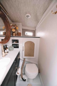 a bathroom with a sink, mirror and toilet in the back ground is seen from above