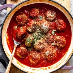 a pot filled with meatballs covered in marinara sauce