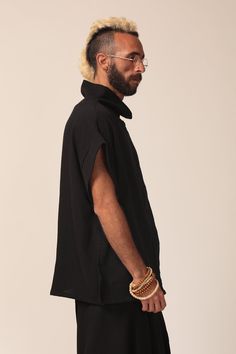 "This beautiful and comfortable black oversize top is a unique piece to have in any closet. It has a stylish urban look with an interesting loose neck line. The shirt is made from high quality cotton and can be worn both in summer and winter. This shirt can be paired with leggings, skinny jeans and a pencil skirt. Material: Cotton Sizes: Men's One Size Measurements: Height: 27.9\" Width: 47.2\" Sleeve: 11.42\" Care instructions: - Turn garment inside out before washing - Hand wash in cold water Oversized Black Cotton Blouse, Oversized Black Summer Tops, Black Cotton Lagenlook Blouse, Casual Oversized Tunic Top, Black Cotton Tunic For Summer, Relaxed Fit Lagenlook Tunic Top, Relaxed Fit Tunic Top In Lagenlook Style, Black Relaxed Fit Blouse For Layering, Black Short Sleeve Lagenlook Top