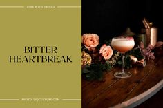 the bitter heart break cocktail is sitting on a table with flowers and candles around it