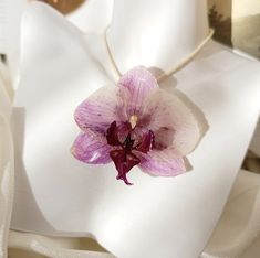 This handmade necklace is designed for you, nature lovers, with the most beautiful Orchid in nature. The purple-white flower was carefully dried and coated with transparent epoxy to remain beautiful for years. It is combined with a soft-textured, cream-coloured, sturdy cotton rope cord. It will gently accompany your combinations, day or night. You can tie the rope length according to your desire. You can contact us for your chain preference. It is unique because it is handmade and made with real White Flower Necklace With Nature-inspired Style, White Flower-shaped Nature-inspired Necklace, Nature-inspired White Necklace For Gift, Nature-inspired White Necklace For Gifts, Nature-inspired White Necklace As Gift, Orchid Flower Necklace For Gift, Natural Color Flower Jewelry For Gifts, Flower Shaped Natural Jewelry For Gift, Flower Shaped Natural Color Jewelry For Gifts