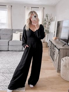 Our Working Gal Jumpsuit features a true black material, v-neckline with surplice front and snap button closure detail, long sleeves with elastic cuffs, smocked waistline, side pockets, wide leg pants with generous room. Approximately 29" inseam Model is 5'1", 34DD, 6-8/28 and is wearing a size small. Item runs slightly big - model sized down one from normal. If larger chest stick with true size. Also shown a 5'9" model in size small for a taller reference. More details: 100% polyester. hand was Black Jumpsuit, Snap Button, Leg Pants, Wide Leg Pants, Smocking, Final Sale, Wide Leg, Jumpsuit, Long Sleeves