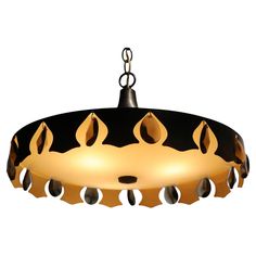 a black and gold chandelier hanging from a ceiling fixture with lights on it