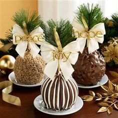 three different types of christmas candies on plates with ribbons and decorations in the background