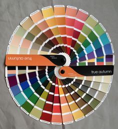 a color wheel with different shades of paint on it and the words true autumn written in black