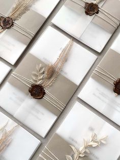 many different types of cards with leaves and ribbons on them, all lined up in rows