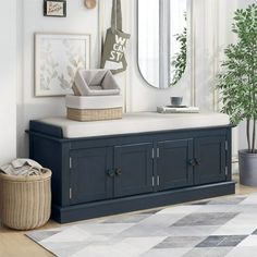 a living room with a couch, mirror and potted plant on the sideboard