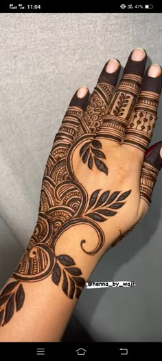 a woman's hand with henna tattoos on it