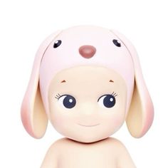 a small toy dog with big eyes and a pink hat on it's head