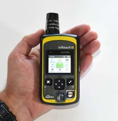 a hand holding a yellow and black cellphone with an inreach message on it