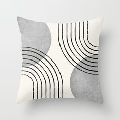 a gray and white pillow with black lines on the front, in an abstract manner