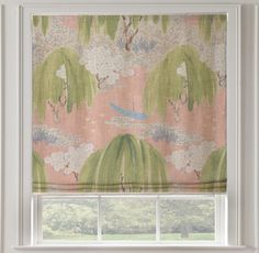 a window with a pink and green curtain in front of it