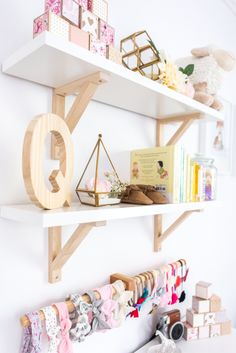 the shelves are filled with various items and decorations for girls's room or baby's nursery