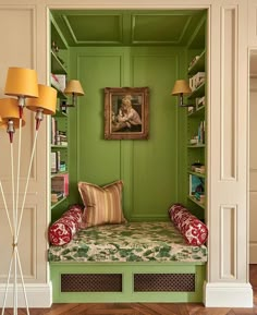 a green room with a bench and two lamps on either side of the room,