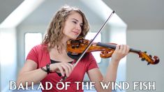 a woman is playing the violin in an empty room with words that read, ballard of the wind fish