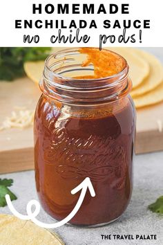 homemade enchilada sauce in a mason jar with text overlay that reads, how to make enchilada sauce no chile poas the travel palate