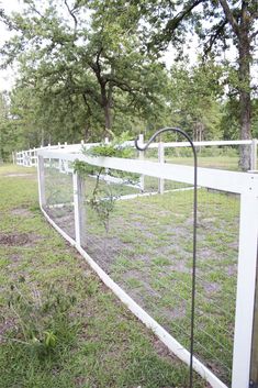 a white fence in the middle of a field