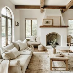 a living room filled with furniture and a fire place in the middle of a room