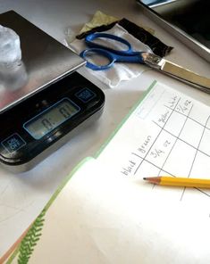 a calculator sitting on top of a table next to a pencil