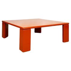 an orange table with two legs on it