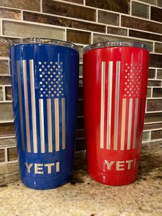 two red and blue yeti tumblers sitting next to each other on a counter