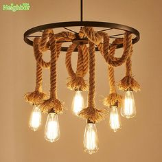 a chandelier with rope and light bulbs hanging from it