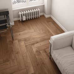 an image of a room with wood flooring and radiator on the wall