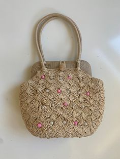 "Vintage Faux Raffia Handbag 1960s 70s Off White Bamboo Handle Free shipping  This handbag is perfect for your resort-wear or spring/summer wardrobe. It looks barely used. The inside is lined with cotton fabric and has one small open pocket. There is no brand label, but it does say \"Made in Japan\". The inside is a little dirty, but not bad at all. The outside has no flaws to note. It has a gold tone metal kiss closure and the handle is bamboo. It also has metal feet on the bottom to prevent wear and tear.  12\" wide by 6.5\" tall by 4.5\" deep. Handle has a 5\" drop" Spring Evening Shoulder Bag In Natural Color, Spring Evening Natural Shoulder Bag, Vintage Summer Bag With Braided Handles, Vintage Straw Bag For Daily Use, Vintage Beige Straw Bag For Travel, Retro Summer Straw Bag For Everyday Use, Vintage Shoulder Bag With Braided Handles, Vintage Handheld Shoulder Bag With Braided Handles, Vintage Satchel Bags For Vacation