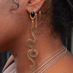 Slither up, slither down. A pair of golden snakes dangle asymmetrically in a pair of statement earrings in gold plating & enamel. Handmade by La Libertad in their Colombia Studio. Golden Snake, Welding Shop, Stacking Bands, Earrings In Gold, Enamel Earrings, Piercing Jewelry, Snakes, Earring Necklace, Gold Plating