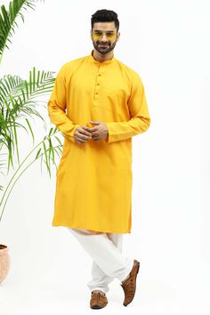 BLUESAANCHI MEN'S YELLOW DESIGNER MATKA SILK KURTA SET  The Bluesaanchi Men's Yellow Designer Matka Silk Kurta Set is a striking blend of tradition and style. With its vibrant yellow hue and premium silk texture, this kurta set offers both comfort and elegance, making it perfect for special occasions and festive celebrations.  Features  Designer yellow Matka silk kurta with intricate detailing  Comfortable fit with a traditional yet modern silhouette  Comes with matching bottoms for a complete s Casual Long Sleeve Yellow Kurta, Casual Yellow Long Sleeve Kurta, Casual Yellow Kurta For Eid, Yellow Cotton Kurta With Dabka, Yellow Cotton Kurta With Dabka Detail, Yellow Cotton Kurta With Dabka Embroidery, Yellow Naqshi Straight Kurta, Yellow Straight Kurta With Naqshi, Yellow Naqshi Kurta