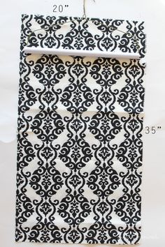 a piece of black and white fabric with an intricate pattern on the bottom half of it