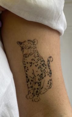 a small tattoo of a cheetah on the side of a woman's leg