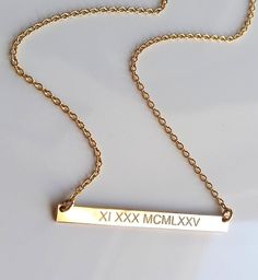 "Simple and shiny 14k gold fill roman numeral date necklace. Custom engraved just for you! The diamond engraving sparkles in the light and can easily become your favorite everyday necklace. I can convert any date into roman numerals for you. I use the USA format by default unless otherwise specified. If you would like to personalize the back as well, please make sure to select \"hidden message\" in the drop down menu upon checking out. I can engrave up to 25 characters on the back. 14k gold bar Personalized Nameplate Necklace, Gold Bar Necklace Personalized, Roman Numerals Dates, Date Necklace, Bar Necklace Personalized, 16 Inch Necklace, Hidden Message, Nameplate Necklace, Gold Bar Necklace