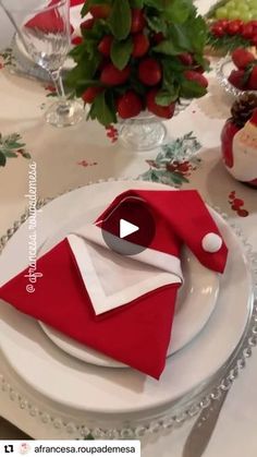 the table is set with red napkins and white plates