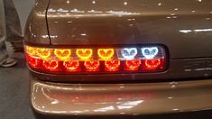 the tail lights of a car are red and yellow