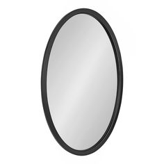 a black oval mirror on a white wall