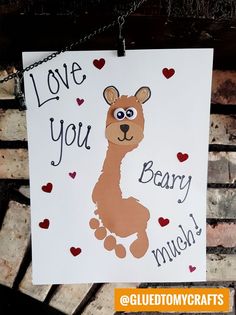 a handmade valentine's card hanging on a chain with the words love you, beary much