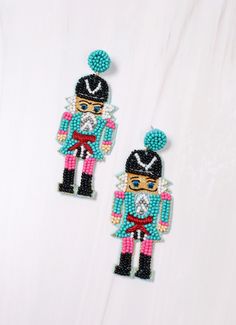 pair of beaded nutcracker earrings on white background