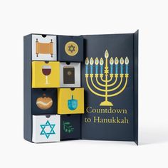 the book is opened to show an image of a menorah and other items